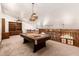 Large game room featuring a pool table, wood railing, and built-in shelving at 119 E Palomino Dr, Tempe, AZ 85284