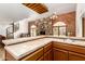 Open kitchen featuring a large island with countertop seating, stainless steel appliances, and tiled floors at 119 E Palomino Dr, Tempe, AZ 85284