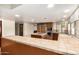 Spacious kitchen featuring a central island cooktop, tile counters, stainless appliances, and ample counter space at 119 E Palomino Dr, Tempe, AZ 85284