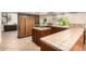 Open kitchen features a central island, a spiral staircase, wood cabinets, a stainless microwave, and ample counter space at 119 E Palomino Dr, Tempe, AZ 85284