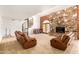 Living room featuring a stone fireplace, spiral staircase, and comfortable seating, perfect for relaxation at 119 E Palomino Dr, Tempe, AZ 85284