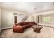 Inviting living room featuring neutral paint, staircase, large windows, and comfortable leather sofa at 119 E Palomino Dr, Tempe, AZ 85284