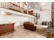 A spacious living room featuring a spiral staircase, fireplace, bar area, and a loft overlooking the space at 119 E Palomino Dr, Tempe, AZ 85284