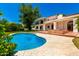 Inviting backyard oasis featuring a private pool, mature trees, and lush landscaping at 119 E Palomino Dr, Tempe, AZ 85284