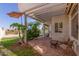Inviting back patio with a pergola, shady umbrella, and manicured landscaping creating a private retreat at 1343 E Amberwood Dr, Phoenix, AZ 85048