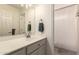 Well-lit bathroom with a white vanity, modern faucet, framed mirror, and a clean shower with a curtain at 1343 E Amberwood Dr, Phoenix, AZ 85048