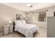 Comfortable bedroom with a large window, light walls, and a modern ceiling fan at 1343 E Amberwood Dr, Phoenix, AZ 85048
