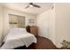 Bright bedroom with hardwood floors, a ceiling fan, and a window, offering comfort and style at 1343 E Amberwood Dr, Phoenix, AZ 85048