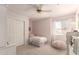 Bedroom features pink walls, closet, a window with blinds and a ceiling fan at 1343 E Amberwood Dr, Phoenix, AZ 85048