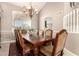 Formal dining room with a decorative chandelier and arched doorway, showcasing elegant features at 1343 E Amberwood Dr, Phoenix, AZ 85048