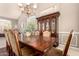 Formal dining room showcasing a china cabinet, chandelier, and an ornate table at 1343 E Amberwood Dr, Phoenix, AZ 85048