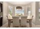 Eat in Kitchen dining area featuring three windows showcasing mountain views and a modern chandelier at 1343 E Amberwood Dr, Phoenix, AZ 85048