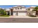 Charming two-story home with a three car garage and manicured lawn in a suburban neighborhood at 1343 E Amberwood Dr, Phoenix, AZ 85048
