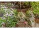 Charming garden nook with gravel path, vine-covered trellis, decorative benches and vibrant foliage for a tranquil experience at 1343 E Amberwood Dr, Phoenix, AZ 85048