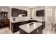 Spacious kitchen with dark cabinets, white countertops, and stainless steel appliances, blending style and functionality at 1343 E Amberwood Dr, Phoenix, AZ 85048