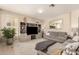 Spacious living room featuring a large sectional sofa and neutral decor at 1343 E Amberwood Dr, Phoenix, AZ 85048