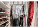 Walk-in closet boasts extensive shelving and hanging space for clothes and accessories at 1343 E Amberwood Dr, Phoenix, AZ 85048