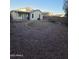 Large gravel backyard with a covered patio for outdoor living and entertaining at 13606 N 130Th Ave, El Mirage, AZ 85335