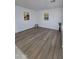 An empty bedroom featuring hard wood floors, and modern-style baseboards and trim at 13606 N 130Th Ave, El Mirage, AZ 85335
