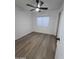 An empty bedroom featuring hard wood floors, and modern-style baseboards and trim at 13606 N 130Th Ave, El Mirage, AZ 85335