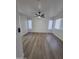 Spacious bedroom featuring new hardwood floors, light, bright white paint and a modern ceiling fan at 13606 N 130Th Ave, El Mirage, AZ 85335