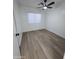An empty bedroom featuring hard wood floors, and modern-style baseboards and trim at 13606 N 130Th Ave, El Mirage, AZ 85335