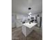 Modern kitchen featuring white cabinets, stainless steel appliances, and center island with pendant lighting at 13606 N 130Th Ave, El Mirage, AZ 85335
