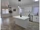 Bright, modern kitchen with an island, sleek appliances, and adjacent living area for open-concept living at 13606 N 130Th Ave, El Mirage, AZ 85335