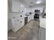 A sleek kitchen featuring stainless steel appliances, white cabinets, and countertops that look like marble at 13606 N 130Th Ave, El Mirage, AZ 85335
