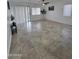 Bright and open living area featuring tile flooring, natural light, and contemporary fixtures at 13606 N 130Th Ave, El Mirage, AZ 85335