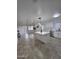 Inviting living room featuring tile flooring, large windows, and modern lighting fixtures at 13606 N 130Th Ave, El Mirage, AZ 85335