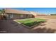 Backyard with green grass surrounded by neutral desert landscape at 1381 W Gary Dr, Chandler, AZ 85224