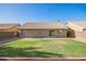 Backyard with green grass and concrete patio with view of home at 1381 W Gary Dr, Chandler, AZ 85224
