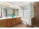 Bathroom featuring dual sinks, tiled shower, and glass block accents, providing a spa-like experience at 1381 W Gary Dr, Chandler, AZ 85224