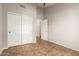Neutral bedroom with closet doors and neutral tile floor at 1381 W Gary Dr, Chandler, AZ 85224
