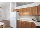 Kitchen area features ample cabinet space, a refrigerator, and easy access to other parts of the house at 1381 W Gary Dr, Chandler, AZ 85224