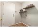 Laundry room with wood shelving, in-wall connections, and white door at 1381 W Gary Dr, Chandler, AZ 85224