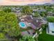 Breathtaking aerial shot of home featuring a sparkling pool and lush landscaping, perfect for outdoor living and entertaining at 14221 N 43Rd St, Phoenix, AZ 85032