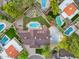 Aerial view of private backyard with sparkling pool, lush landscaping, sport court, and spacious outdoor living areas at 14221 N 43Rd St, Phoenix, AZ 85032