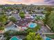 Gorgeous aerial view of home with sparkling pool, sport court, and charming backyard amenities nestled in lush landscape at 14221 N 43Rd St, Phoenix, AZ 85032