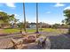 Expansive backyard featuring a fire pit, grassy area, pool, swing set, and ample space for outdoor activities at 14221 N 43Rd St, Phoenix, AZ 85032