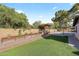 Large backyard featuring a lush lawn, raised planters, and a covered grilling area for outdoor living at 14221 N 43Rd St, Phoenix, AZ 85032