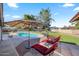 Relaxing backyard with a pool, shaded lounge chairs, and an umbrella table for sunny days at 14221 N 43Rd St, Phoenix, AZ 85032
