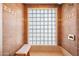 Walk-in shower features block glass for privacy and natural light with a built-in bench at 14221 N 43Rd St, Phoenix, AZ 85032