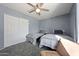 Cozy bedroom with gray walls, two twin beds, a ceiling fan, and plenty of closet space at 14221 N 43Rd St, Phoenix, AZ 85032