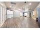 Large bonus room featuring laminate flooring, projector screen, and plenty of natural light at 14221 N 43Rd St, Phoenix, AZ 85032