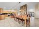 Open dining area with wooden table, modern lighting and view of the living room and kitchen at 14221 N 43Rd St, Phoenix, AZ 85032