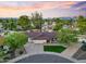 Stunning aerial view of a well-maintained home with lush landscaping and mature trees against a sunset backdrop at 14221 N 43Rd St, Phoenix, AZ 85032