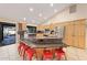 Kitchen island with granite countertop and bar stool seating in a bright, open-concept design at 14221 N 43Rd St, Phoenix, AZ 85032
