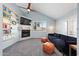 Comfortable living room with vaulted ceilings, built-in shelving, modern fireplace, and large window at 14221 N 43Rd St, Phoenix, AZ 85032